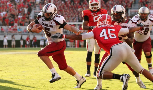 South Carolina's Stephen Garcia breaks away from Georgia's Christian Robinson for a touchdown during third-quarter action in Athens, Ga. on Saturday, Sept. 10, 2011. (Photo by Travis Bell/Sideline Carolina)
