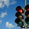 A couple of red traffic lights against a blue sky